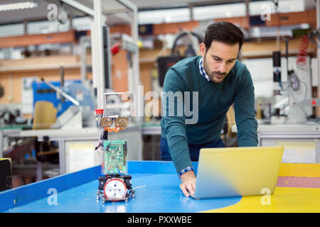 Young student of mechatronics working on project Stock Photo