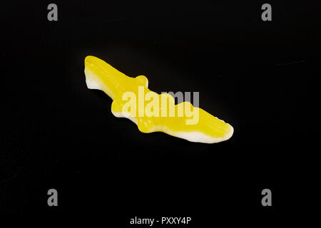 jelly candies in the crocodile shape on a black background. Stock Photo