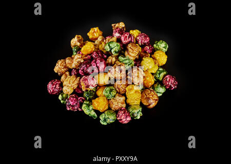 multicolored caramel popcorn on a black background. Stock Photo