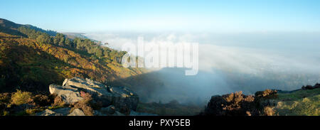 UK landscape panorama: mist rising over an autumnal Wharfedale Valley and Ilkley Moor creating a brocken spectre, West Yorkshire, UK
