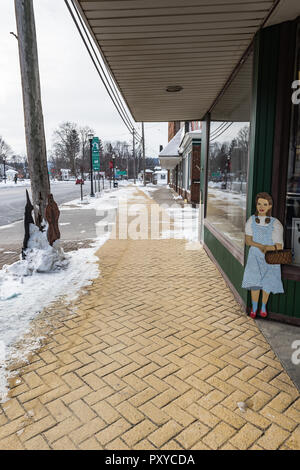 Wood cutout of Dorothy guards The home of L. Frank Baum, author of The Wizard of Oz books, in Chittenango, New York. Stock Photo