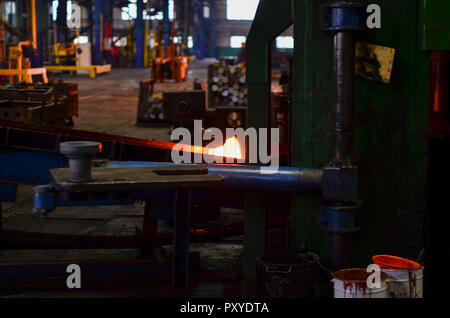 High precision hot forging product, automotive part production by hot forging process, automatice line hot forging. Iron melting recycling work. Heavy Stock Photo