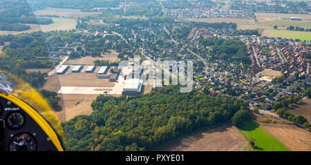 View from the ultralight airplane to a German suburb with offshore fields, meadows, a forest and an industrial area Stock Photo