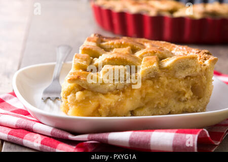 Homemade apple pie slice on wooden table Stock Photo
