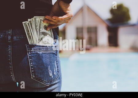 Woman with dollars money in her pocket. Stock Photo