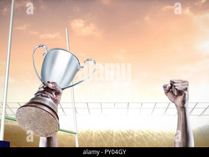 Digital composite image of athlete hands holding trophy Stock Photo