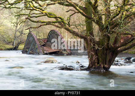 On Saturday 5th December 2015, Storm desmond crashed into the UK, producing the UK''s highest ever 24 hour rainfall total at 341.4mm. It flooded many towns including Keswick. This shots shows one of two railway bridges on the old Keswick railway line that were completely destroyed by the floods. It also shows a tree, now sat in the middle of the river, that used to be growing on the river bank. The force of water was such that it has scoured out huge areas of banking and realigned the river in places.' Stock Photo