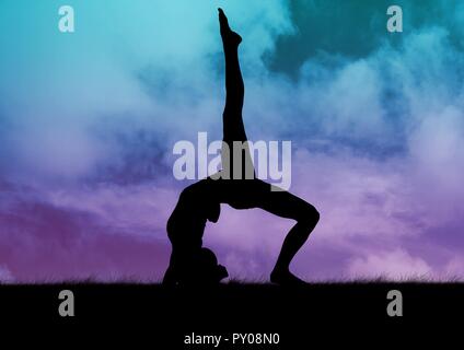 Digital composition of silhouette of woman practicing yoga on grass against sky background Stock Photo