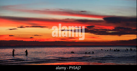 Silhouettes of tourists swimming in sea at sunset, Boracay, Aklan, Philippines Stock Photo
