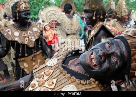 Funny old man in front of group of people, wearing tribal costumes at Ati Atihan festival, Kalibo, Aklan, Panay Island, Philippines Stock Photo