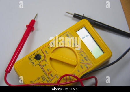 Yellow multimeter for learning how to use this tool, it is also useful at home to carry out checks on home electronic devices Stock Photo