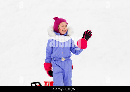 happy little girl waving hand outdoor in winter Stock Photo