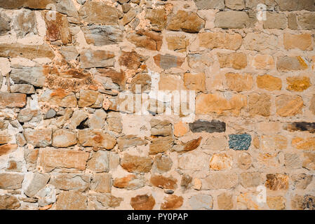 Ancient wall from big colourful brick square stones Stock Photo