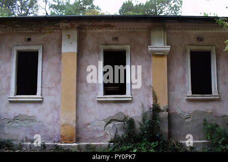 Three windows in an abandoned building Stock Photo
