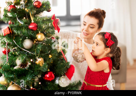 happy family decorating christmas tree at home Stock Photo