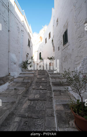 Ostuni Italy. White washed buildings on a stepped street in Ostuni in Puglia, Southern Italy.
