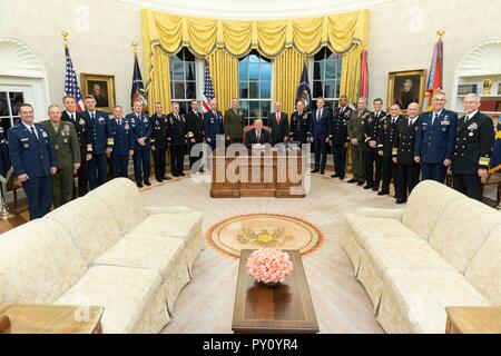 U.S President Donald Trump poses for a photo with senior military commanders in the Oval Office of the White House October 23, 2018 in Washington, DC. Stock Photo
