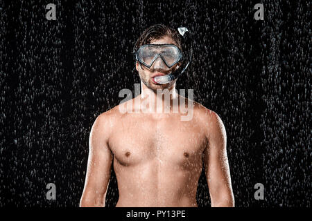 portrait of shirtless man in swimming mask with snorkel standing