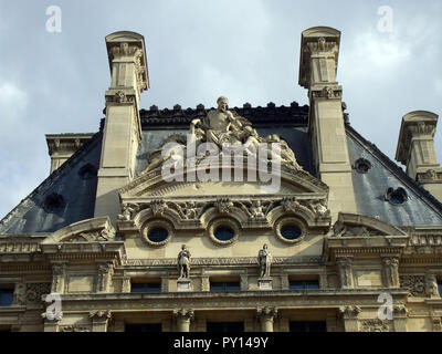 Detail of a section of roof of the Louvre museum in Paris shows some wonderful and astonishing architectural detail and many classical and elaborate designs from statues, windows, sculptures that would not look out of place on the inside of the building. Stock Photo