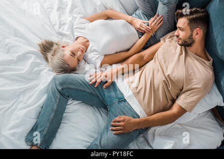 overhead view of beautiful young couple relaxing together in bedroom Stock Photo