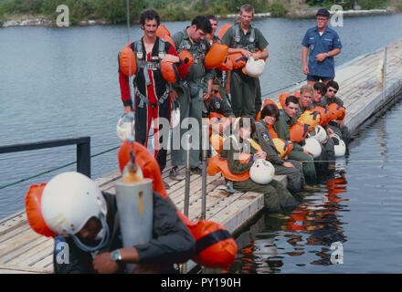 The first female NASA astronauts qualify in Water Survival School at Turkey Point, Florida. Here NASA astronaut candidates Anna L. Fisher and Sally Ride sit among their male classmates as they await their turn in a helicopter water pickup exercise. Stock Photo