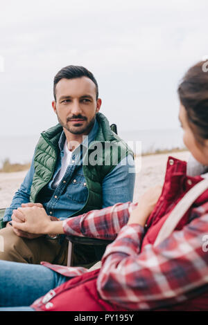 man and woman holding hands while enjoying camping together Stock Photo