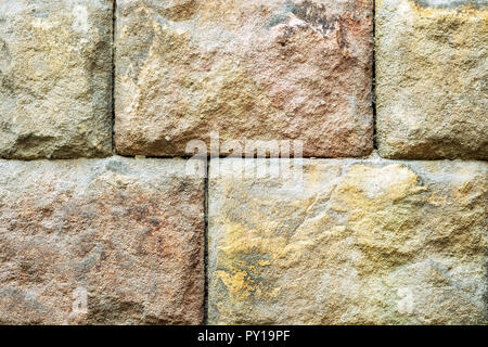 Wall of variegated stone blocks for use as a background. Stock Photo