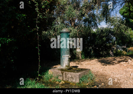 Water column in the street with concrete base and flowing water Stock Photo