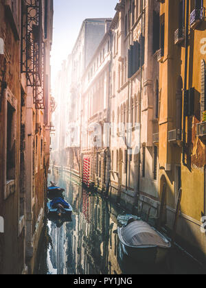 Warm morning in venice, sun approaching the narrow water channel Stock Photo