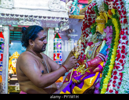 SINGAPORE - FEB 24 : Indian man decorating idol in Sri Veeramakaliamman temple in Little India, Singapore on February 24 2018 It is one of the oldest  Stock Photo