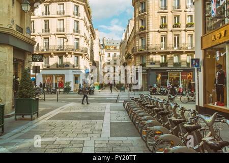 Historic street at the 4th Arrondissement in Paris with public rental bicycles, France Stock Photo