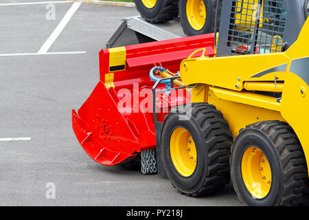 Skid steer construction machine with interchangeable attachment Stock Photo