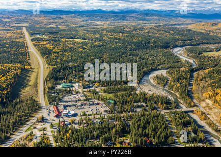 Aerial  view of the hamlet of Bragg Creek, Alberta with Rockies in background. Stock Photo