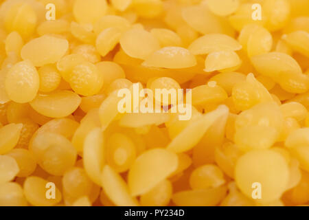 A Background of Natural Yellow Beeswax Pearls Stock Photo