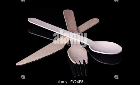 Environmentally friendly wooden cutlery on a black background Stock Photo