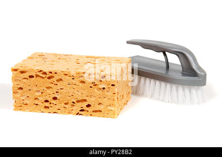 Big porous sponge with scrubbing brush isolated on white background. Stock Photo