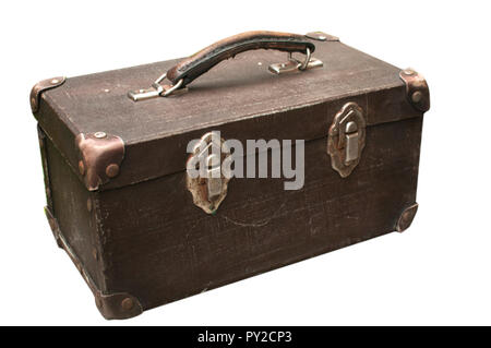 Old used weathered vintage grunge suitcase on stone pavement closeup isolated on white background Stock Photo