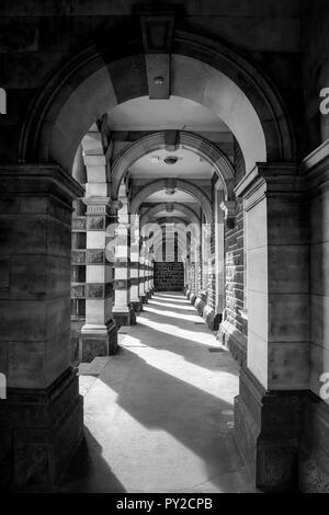 Archway in Dunedin, New Zealand that shows light and dark shadows, leading lines, with a hook in the centre of the image to rest your eye, fine art Stock Photo