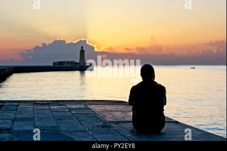 Rear view of man looking at sunset, Valletta, Malta Stock Photo
