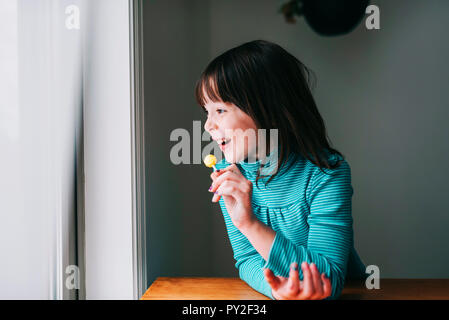 Portrait of a smiling girl with a lollipop Stock Photo