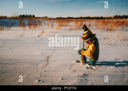 Boy walking in deep snow, United States Stock Photo