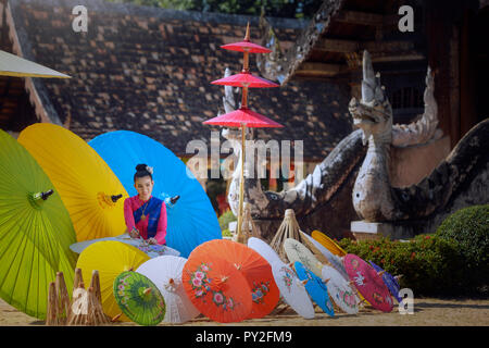 Portrait of a woman painting traditional parasols, Chiang Mai, Thailand Stock Photo