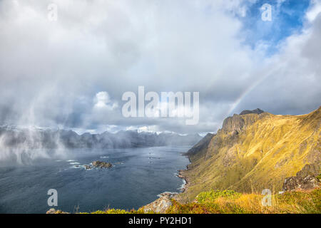 Fading rainbow through storm clouds, Lofoten, Nordland, Norway Stock Photo