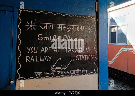 Sign saying 'smile please you are at Taradevi station' on the Shimla toy train line Stock Photo