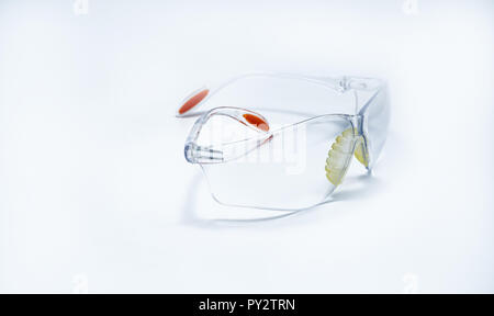 Plastic safety glasses isolated on white background. Goggles for protective eye of worker at construction site or in factory. Safety and security tool