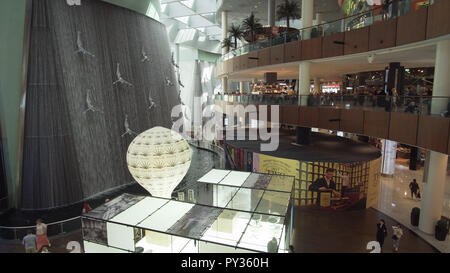 Waterfall with divers after pearls in the Dubai Mall, the world's largest shopping center Stock Photo