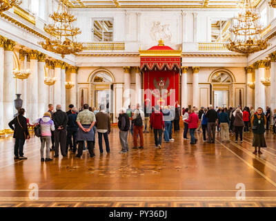 19 September 2018: St Petersburg, Russia - Visitors in St George's Hall, or the Great Throne Room, in the Winter Palace, part of the Hermitage Museum. Stock Photo