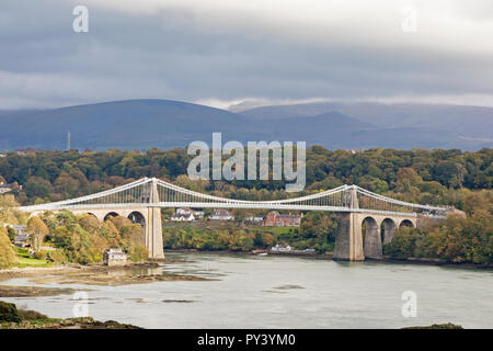 The Menai Suspension Bridge spanning the Menai Strait in autumn light, North Wales, UK Stock Photo