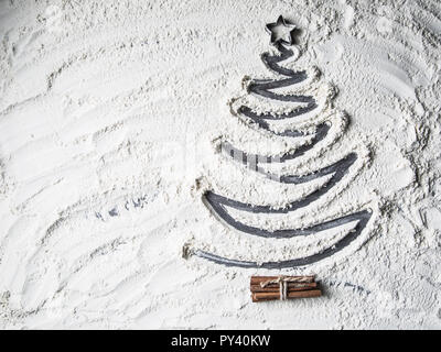 Top of view shaped christmas tree of flour star and cinnamon. Stock Photo
