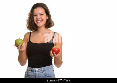 Young happy Caucasian teenage girl smiling holding red and green Stock Photo